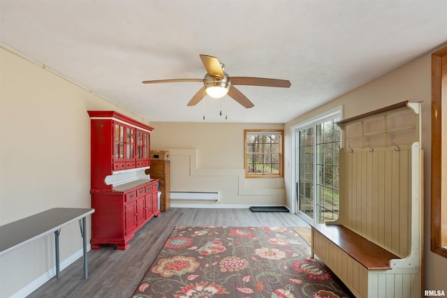 interior space featuring a ceiling fan, wood finished floors, and baseboard heating