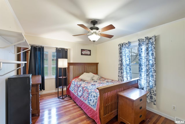 bedroom featuring crown molding, visible vents, baseboards, and wood finished floors