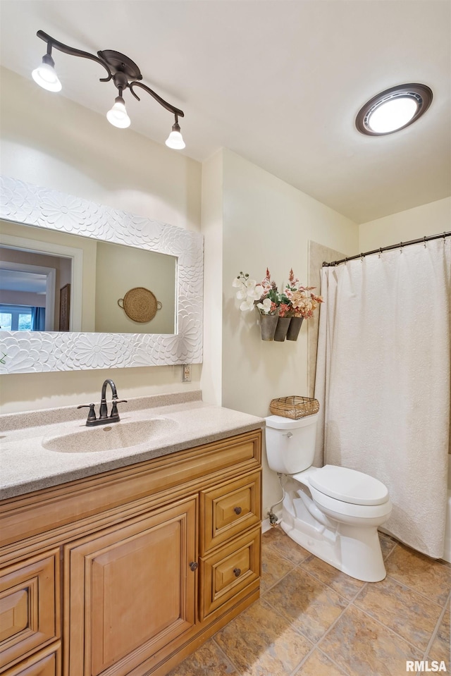 bathroom with vanity, a ceiling fan, and toilet