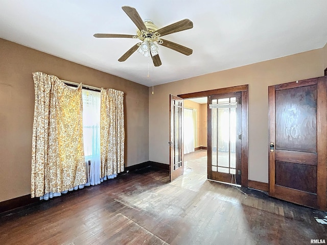 unfurnished room with ceiling fan, french doors, and wood-type flooring