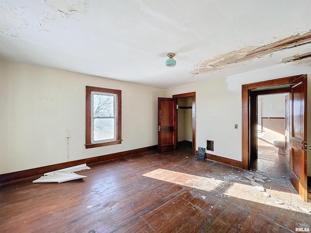 unfurnished bedroom with dark hardwood / wood-style floors