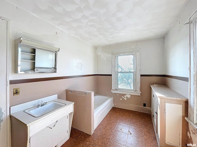 bathroom with a bathing tub and sink