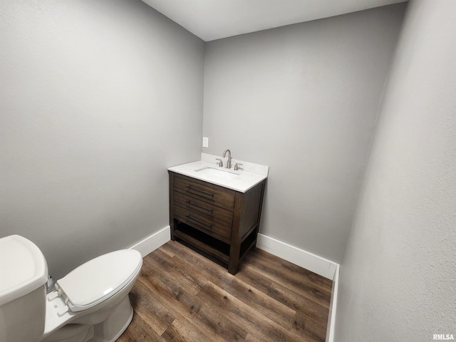 bathroom with vanity, wood-type flooring, and toilet