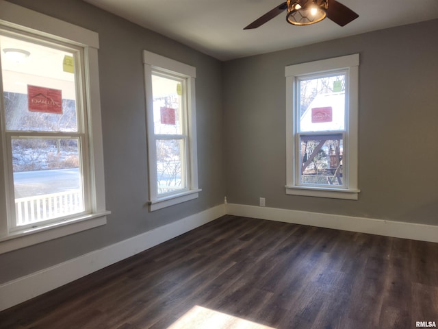 spare room with ceiling fan and dark wood-type flooring