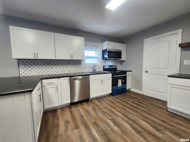 kitchen with white cabinetry, sink, tasteful backsplash, dark hardwood / wood-style flooring, and appliances with stainless steel finishes