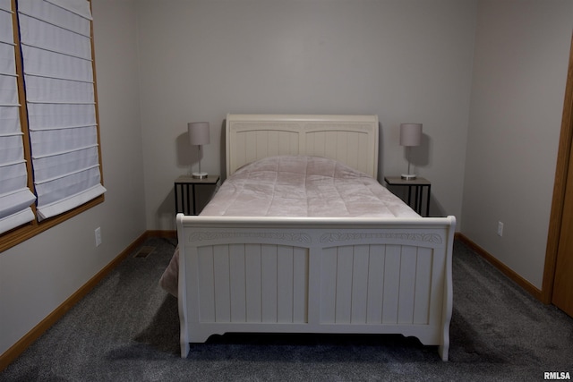 bedroom with dark colored carpet