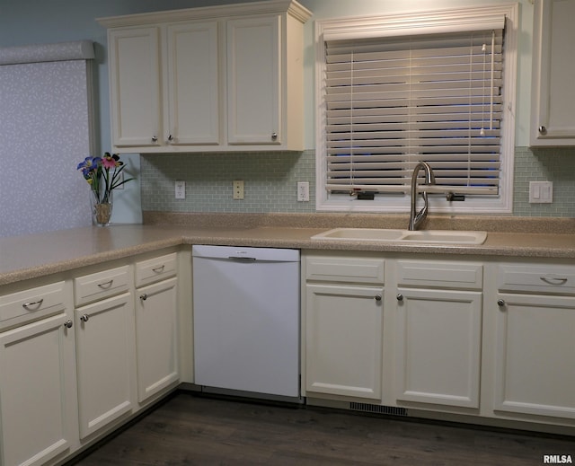 kitchen featuring dishwasher, backsplash, white cabinets, and sink