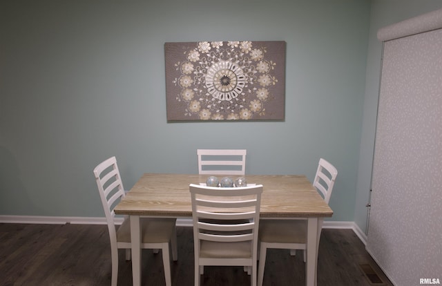 dining space with dark hardwood / wood-style floors