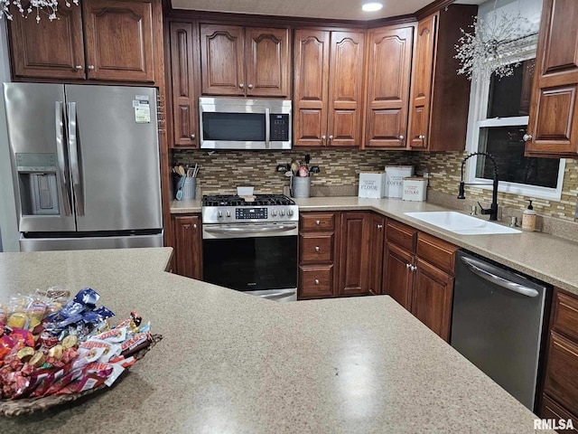 kitchen featuring sink, decorative backsplash, and appliances with stainless steel finishes