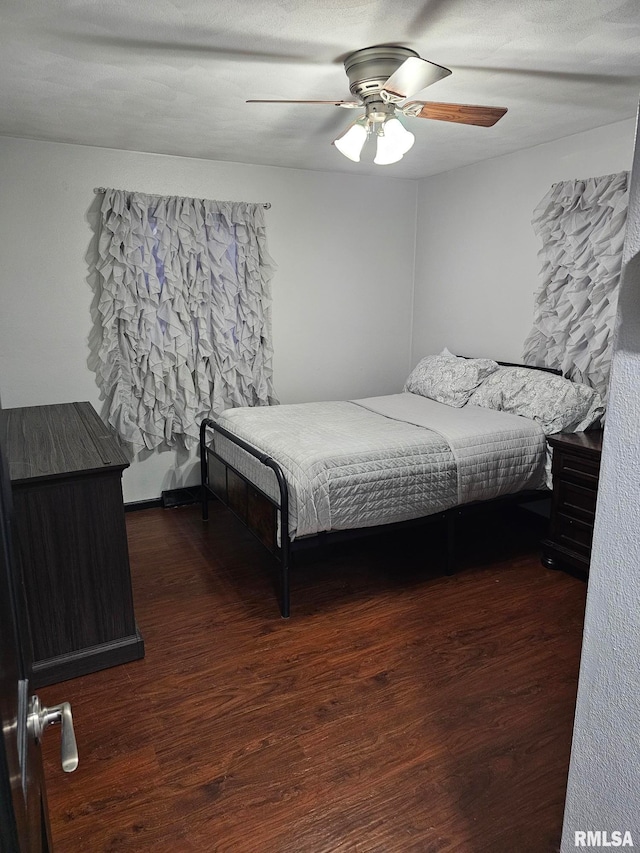 bedroom featuring dark hardwood / wood-style floors and ceiling fan