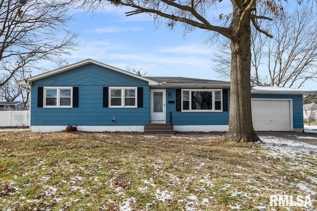 view of front of home with entry steps, driveway, a garage, and a yard