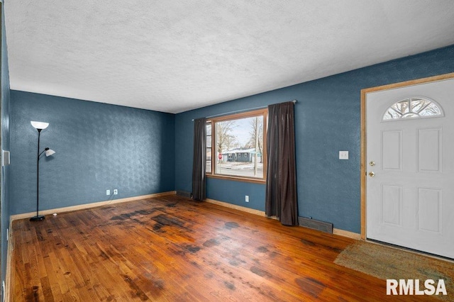 entryway featuring a textured ceiling and dark hardwood / wood-style floors