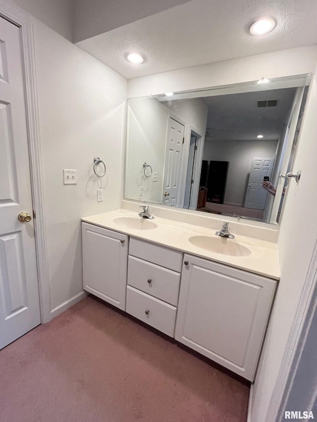 bathroom with vanity and a textured ceiling