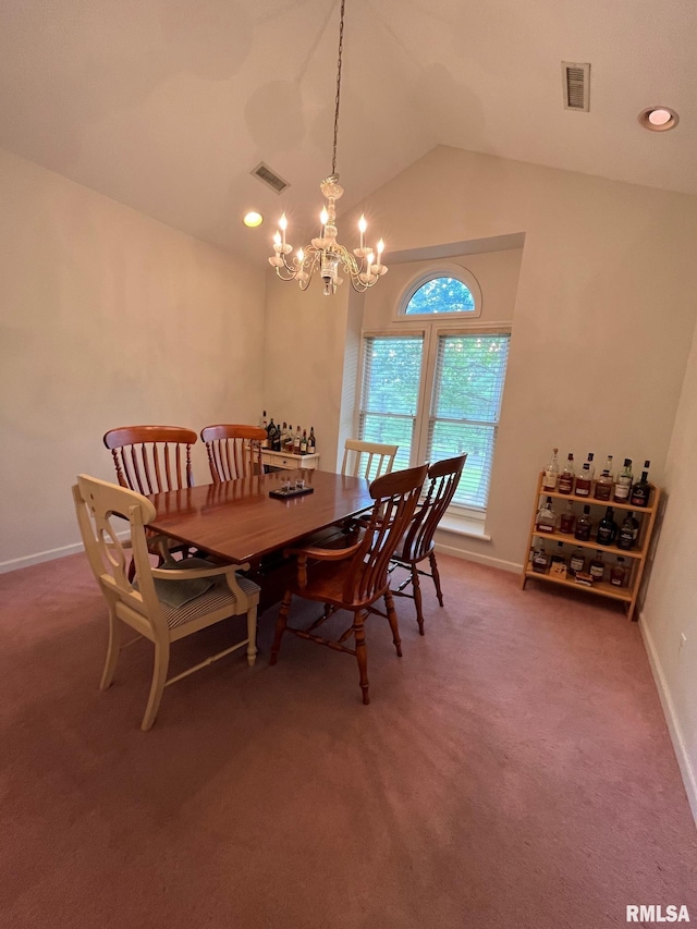 carpeted dining room featuring a chandelier and lofted ceiling