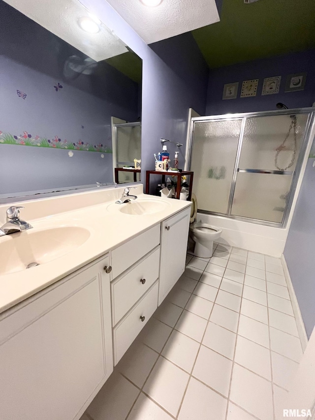 full bathroom featuring vanity, tile patterned flooring, toilet, enclosed tub / shower combo, and a textured ceiling