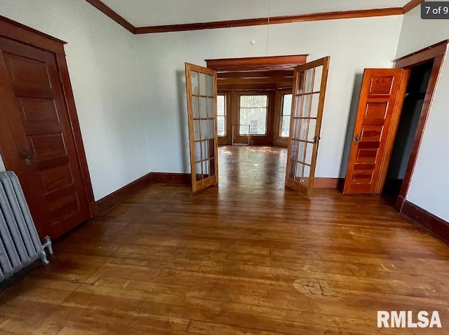 corridor with radiator, crown molding, french doors, and dark hardwood / wood-style flooring