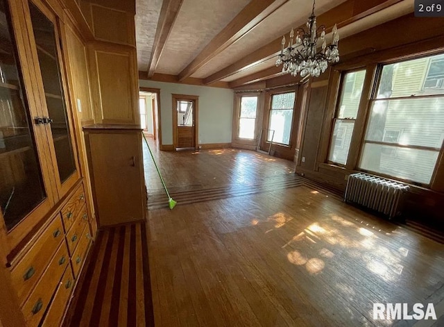 interior space with radiator heating unit, dark hardwood / wood-style flooring, a notable chandelier, and beam ceiling