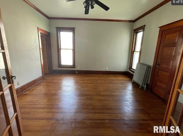 unfurnished room with radiator, ceiling fan, dark hardwood / wood-style floors, and ornamental molding