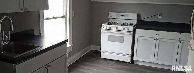 kitchen featuring white cabinets, a wealth of natural light, and gas range gas stove