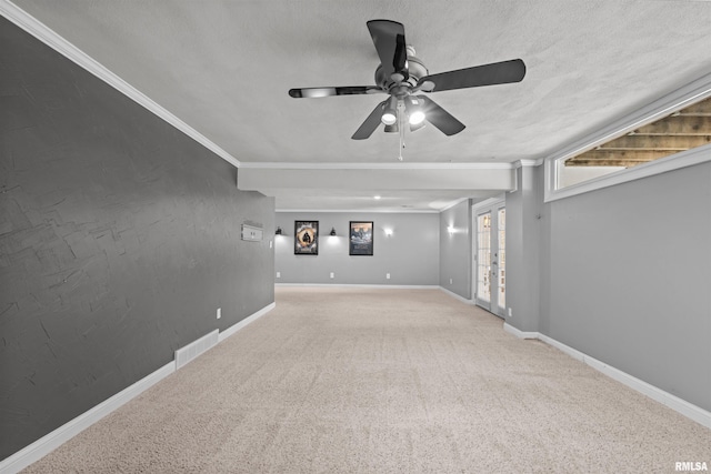 carpeted empty room with crown molding, ceiling fan, and a textured ceiling