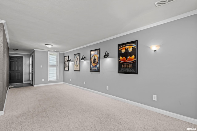 empty room featuring carpet and ornamental molding