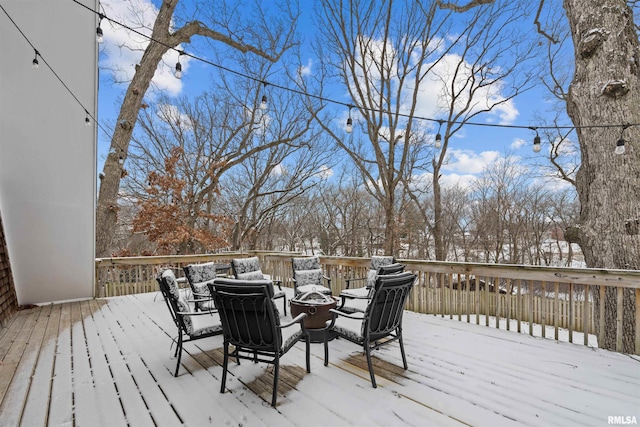 snow covered deck with a fire pit