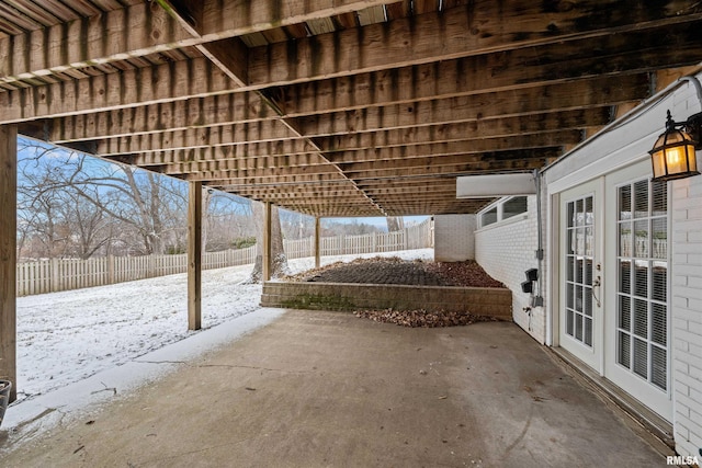 snow covered patio with french doors