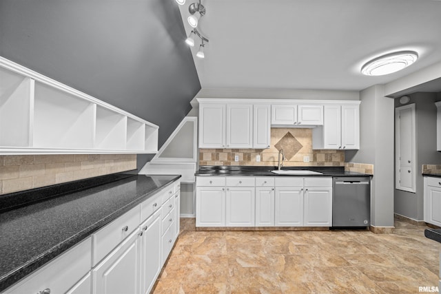 kitchen featuring white cabinets, dishwasher, decorative backsplash, and sink