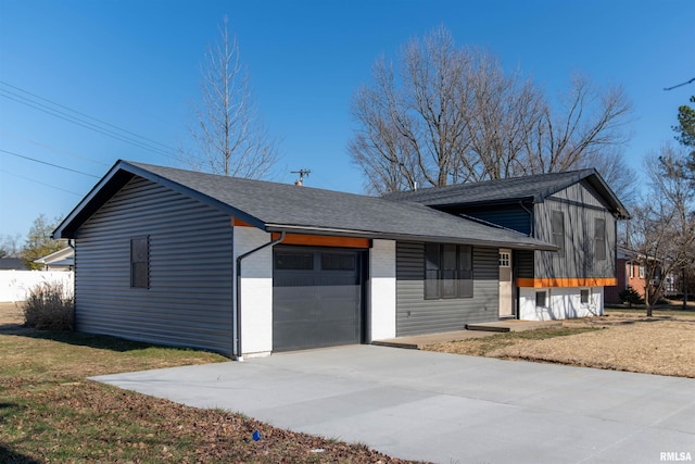 view of front of property with a front yard and a garage