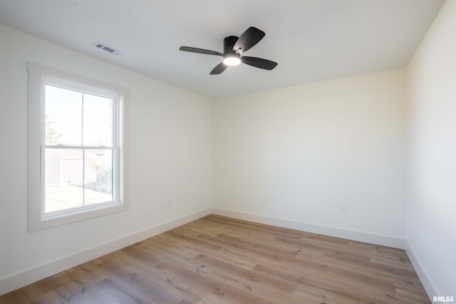 empty room featuring ceiling fan and light hardwood / wood-style flooring