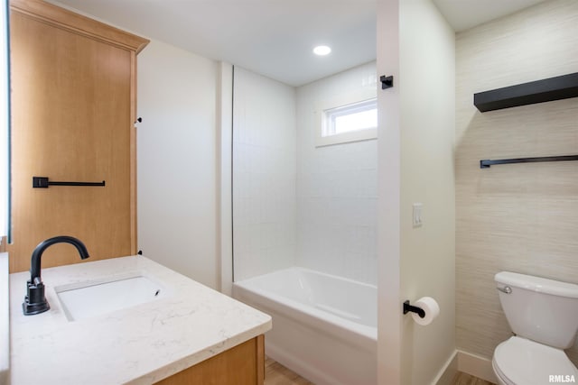 full bathroom with toilet, vanity, and  shower combination