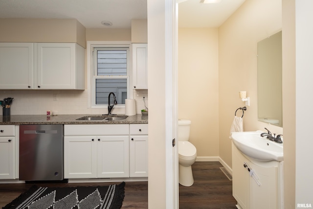 bathroom with hardwood / wood-style floors, vanity, toilet, and tasteful backsplash