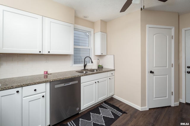 kitchen with dishwasher, dark stone counters, sink, dark hardwood / wood-style flooring, and white cabinetry