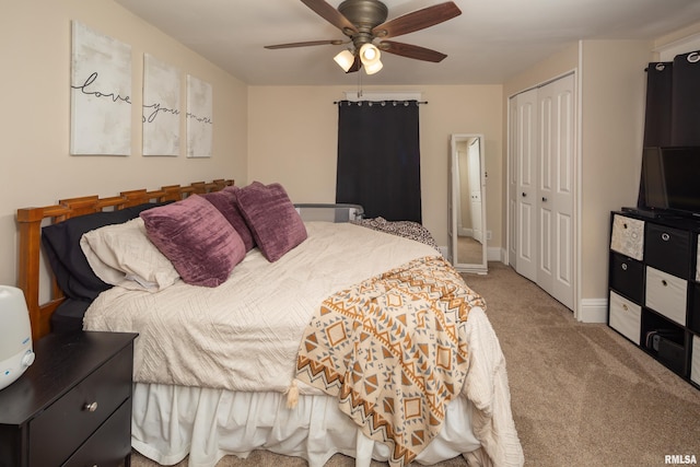 bedroom with ceiling fan, a closet, and light carpet