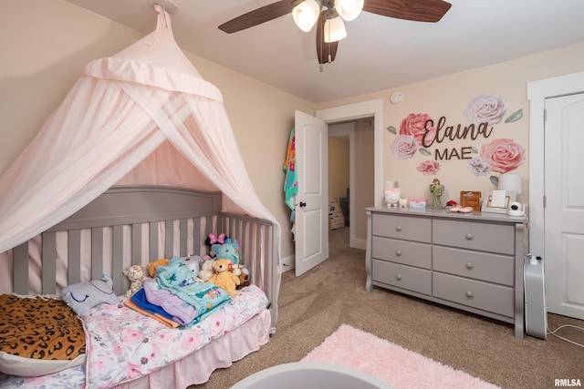 bedroom featuring light colored carpet and ceiling fan