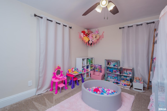 playroom with light carpet and ceiling fan