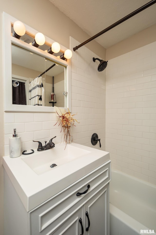 bathroom with sink and tasteful backsplash