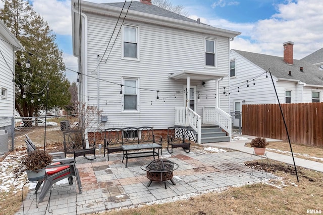 rear view of house featuring a patio and a fire pit