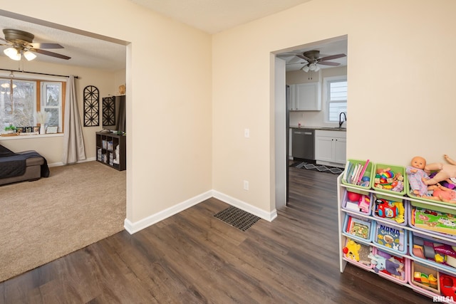 playroom with dark hardwood / wood-style flooring and ceiling fan