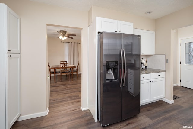 kitchen with white cabinets, stainless steel fridge, ceiling fan, and dark wood-type flooring