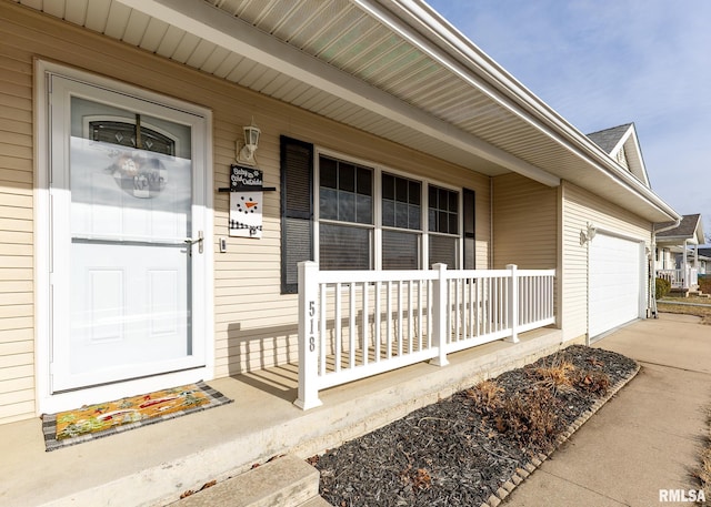 doorway to property featuring a porch and a garage