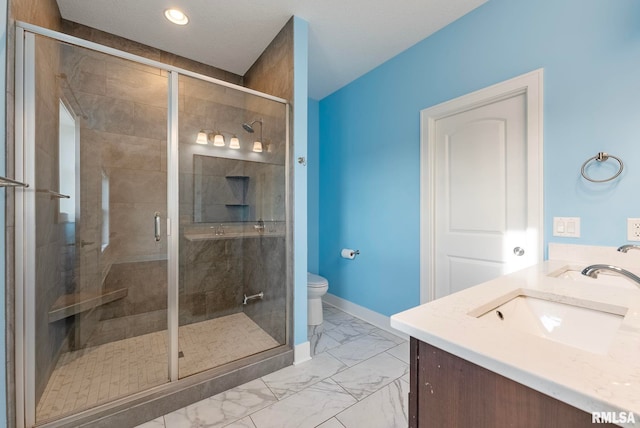 bathroom with vanity, toilet, and walk in shower