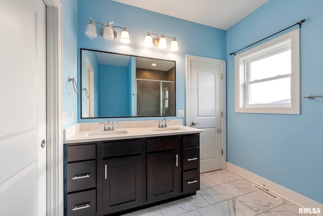 bathroom with a shower with door and vanity