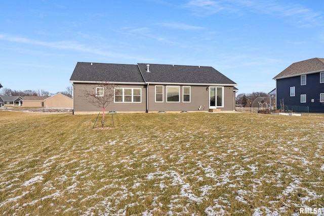 rear view of property with a lawn