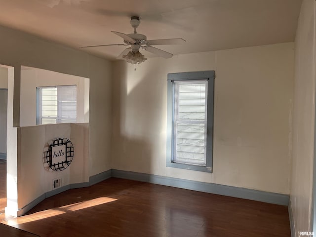 spare room featuring ceiling fan and dark hardwood / wood-style flooring