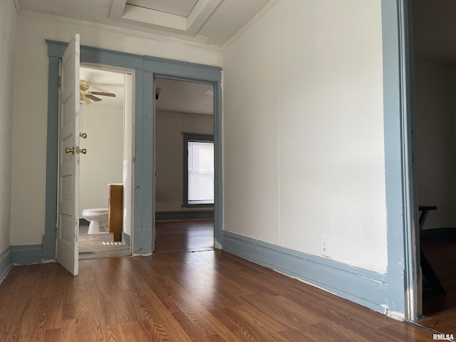 unfurnished room featuring ceiling fan, dark hardwood / wood-style flooring, and ornamental molding