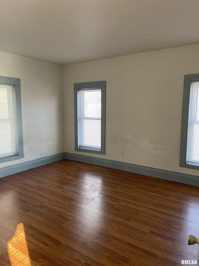 empty room with dark hardwood / wood-style flooring