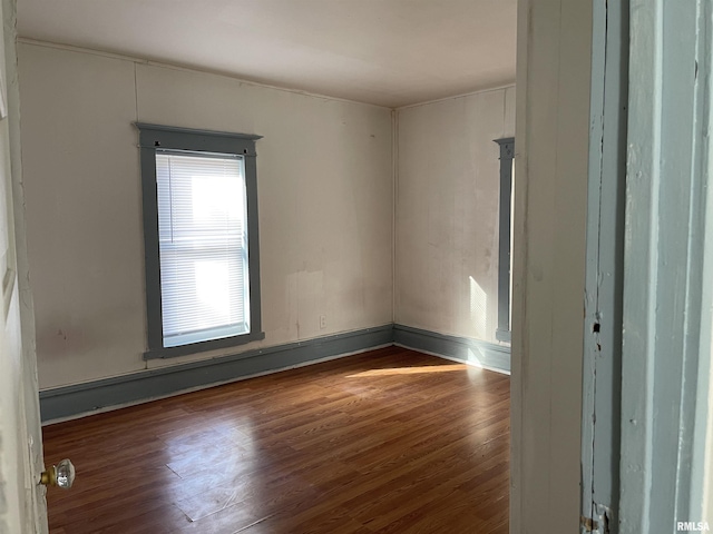 unfurnished room with dark hardwood / wood-style floors