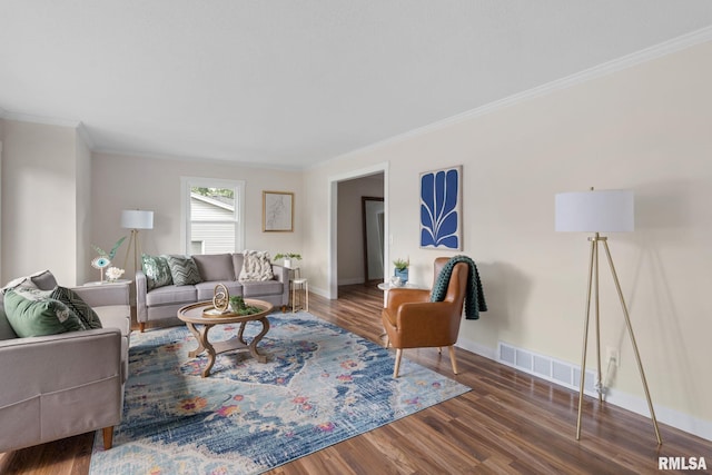 living room with dark hardwood / wood-style flooring and ornamental molding