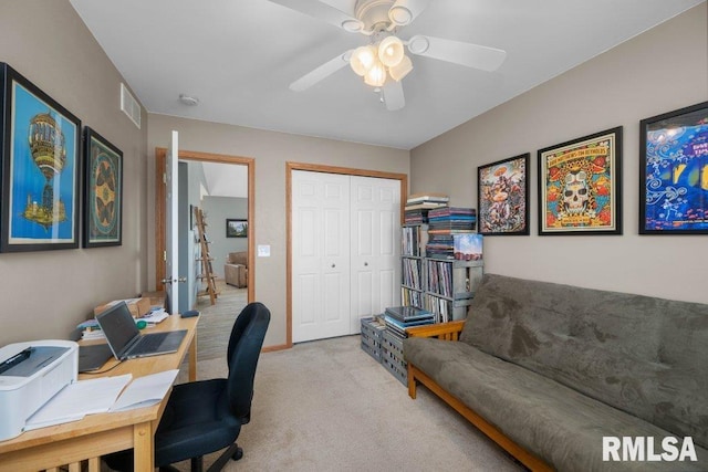 home office featuring light carpet and ceiling fan